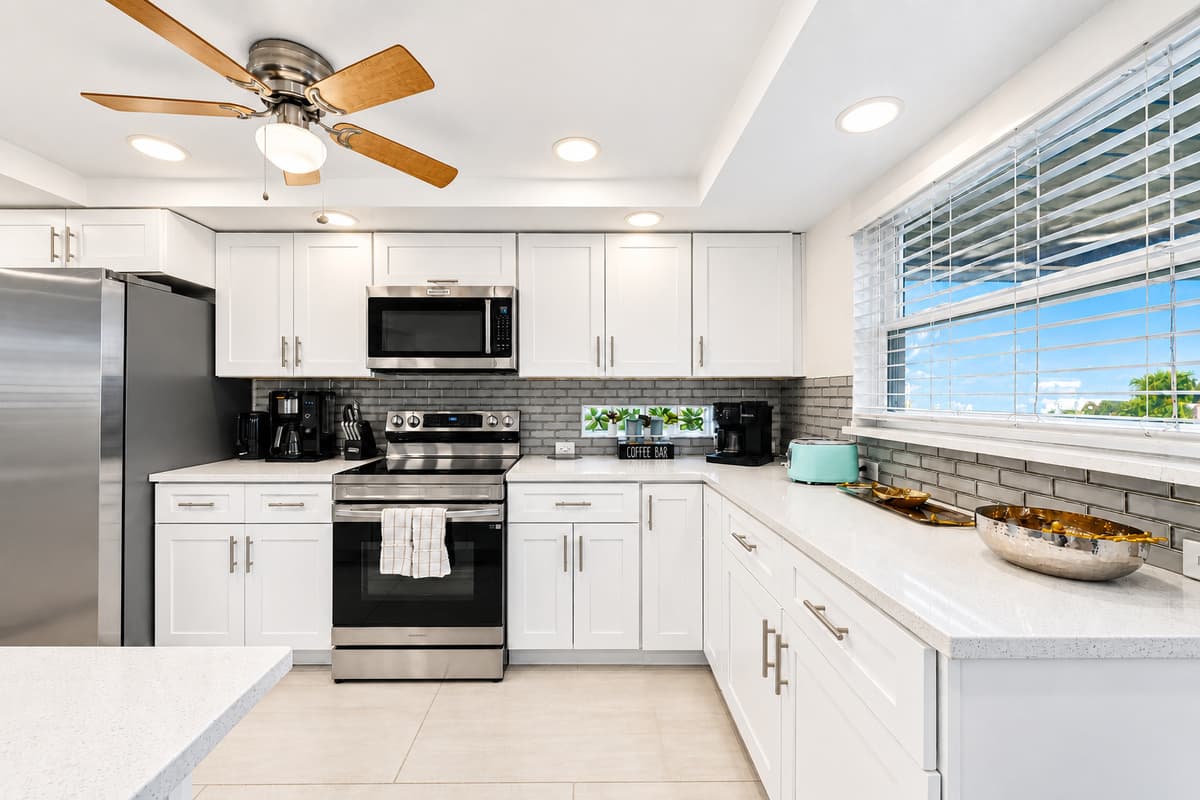 Fully equipped kitchen with contemporary finishes, ample prep space, and natural lighting.