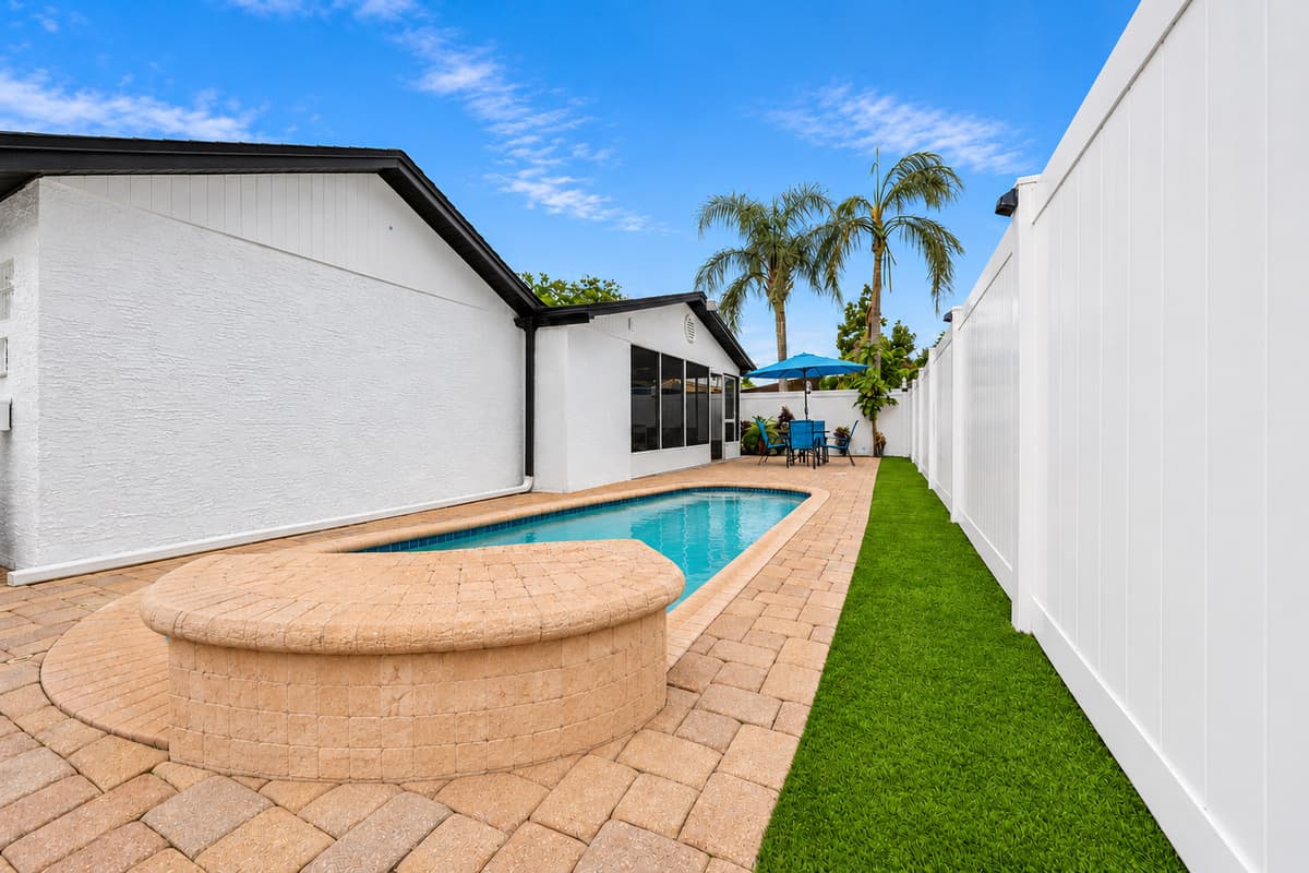 Private swimming pool surrounded by a fully fenced backyard, providing a peaceful and private setting for relaxation and family fun.
