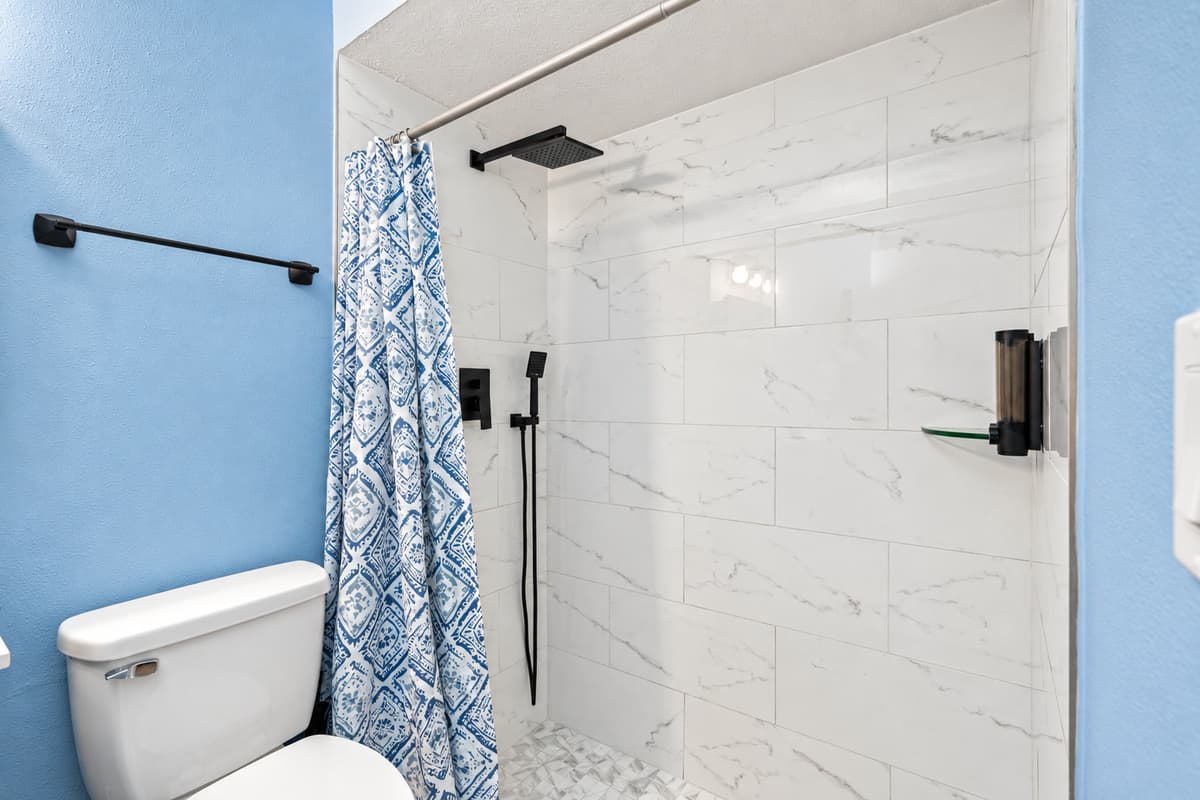 The pristine toilet, complemented by contemporary design elements, ensures utmost comfort and hygiene.