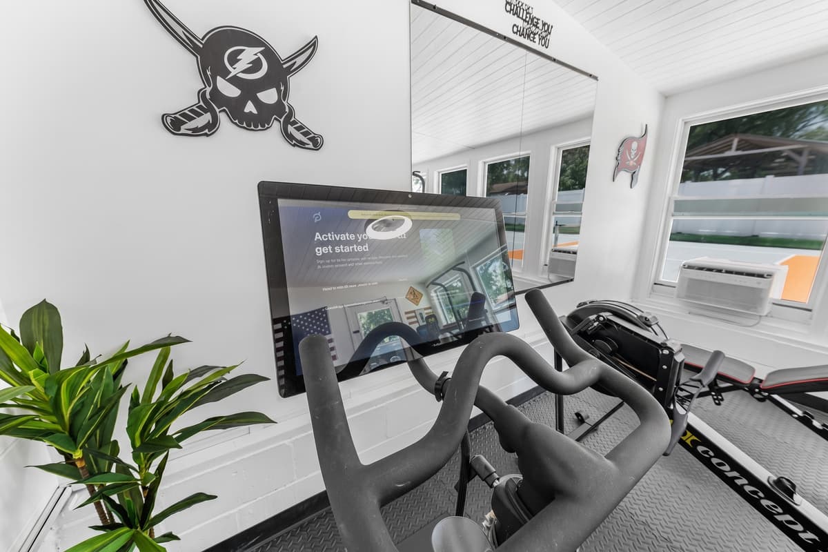 Get your heart pumping with the stationary bike while enjoying bright natural light and backyard views.