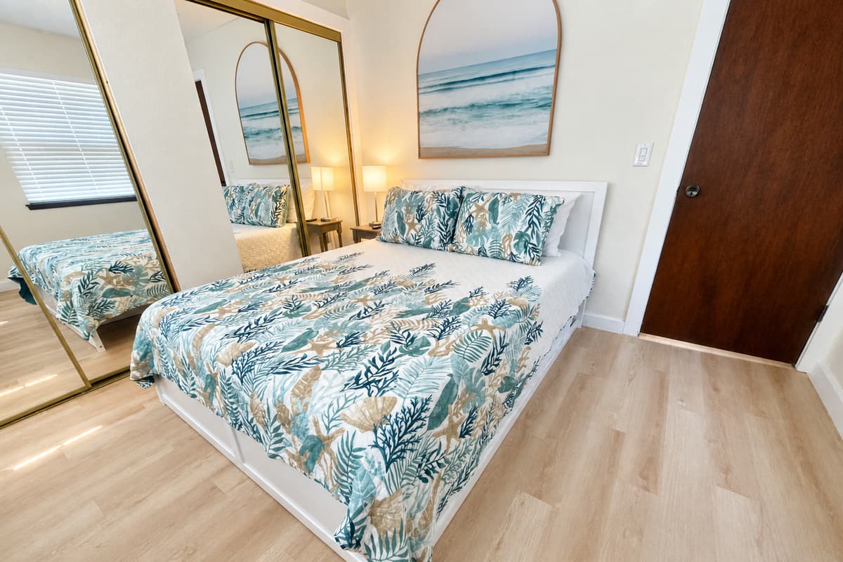 Welcome to our inviting bedroom featuring a cozy queen-size bed. Step into a space designed for comfort and relaxation, where you can unwind and recharge during your stay.