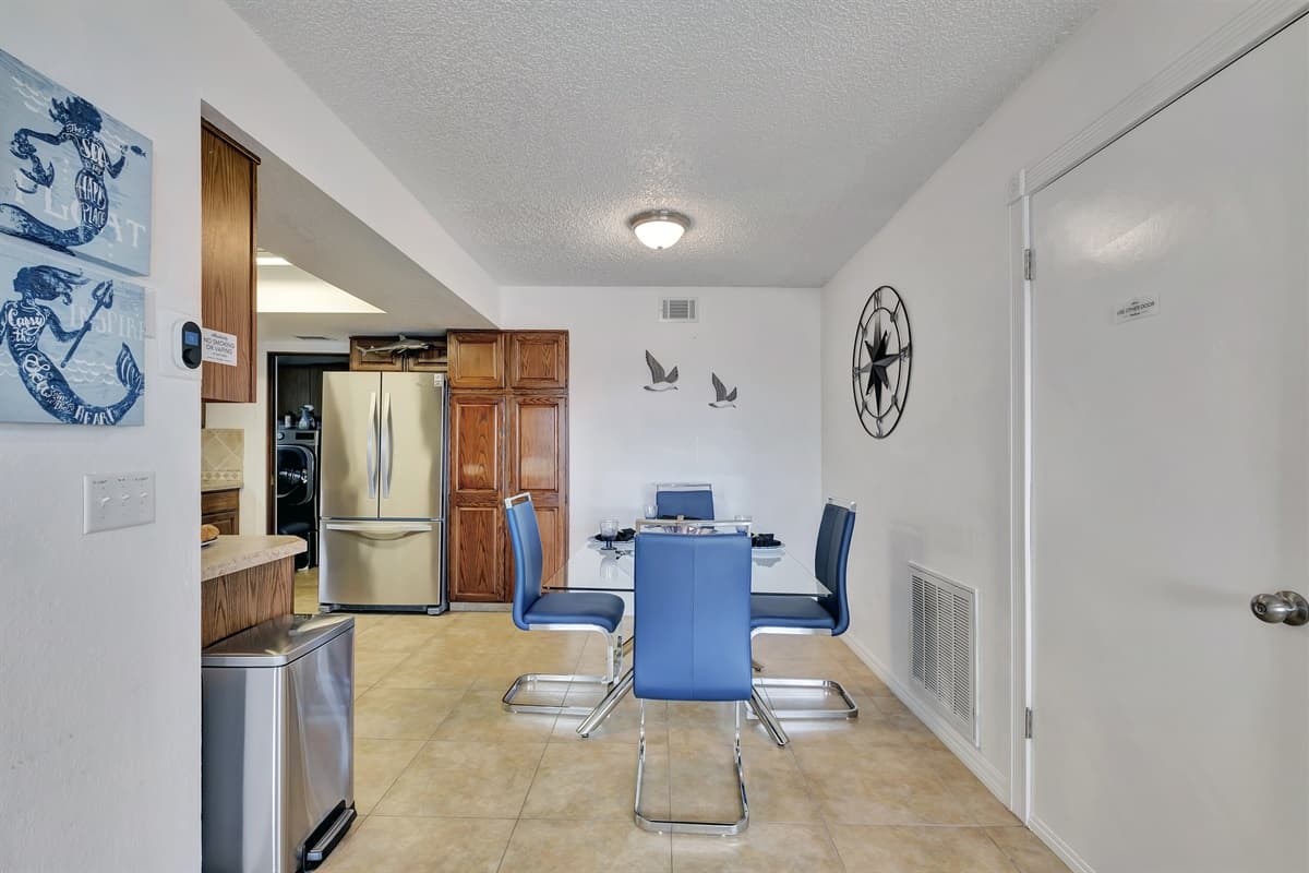 The area is well-lit with a combination of natural light from nearby windows and stylish overhead lighting, which creates a warm and welcoming ambiance, perfect for any time of day.