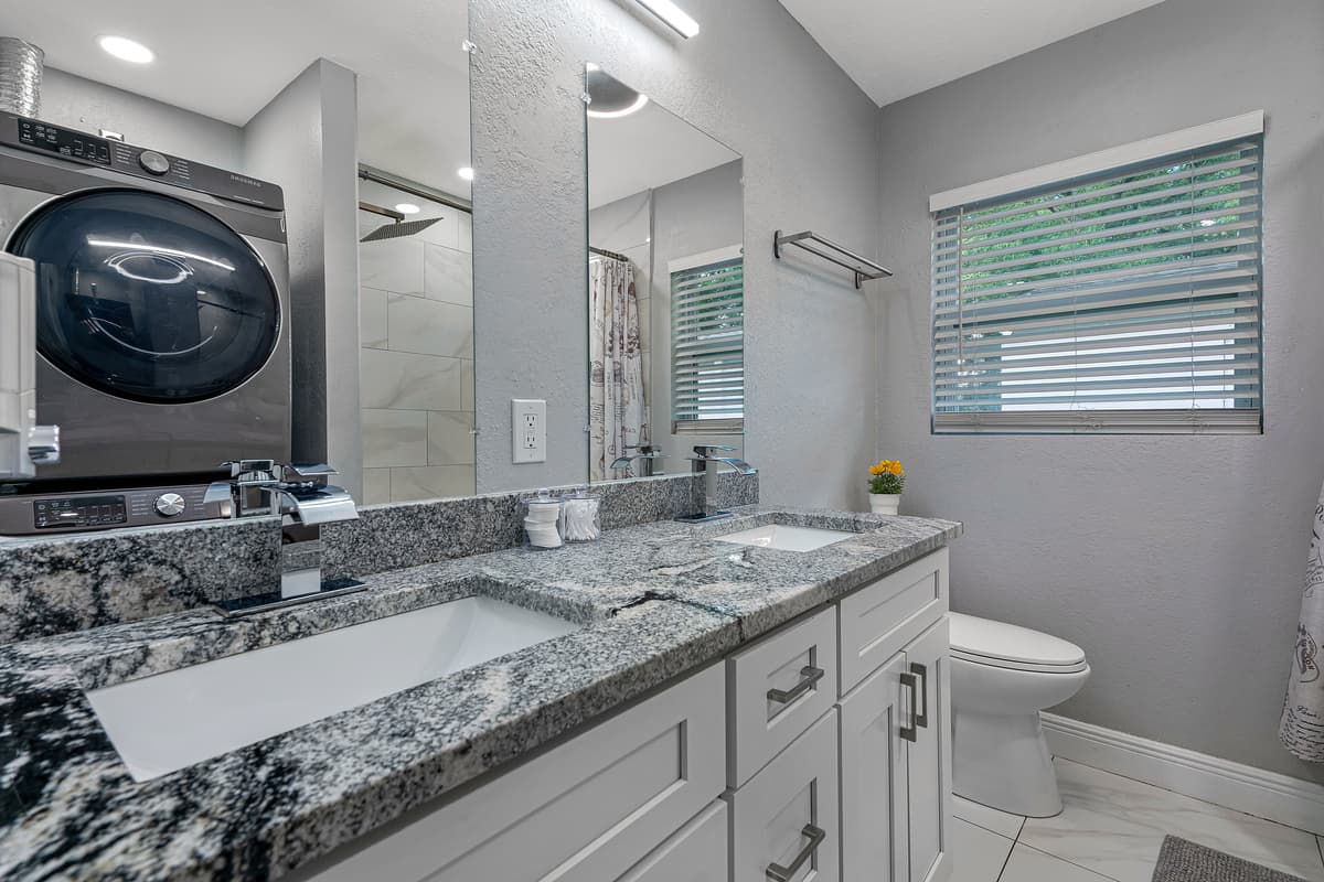Stunning bathroom has his and hers sink, toilet, bathtub and a shower. Enjoy a relaxing bath after a long day of travel from your home to your home away from home. If you like this property, send us a message now!