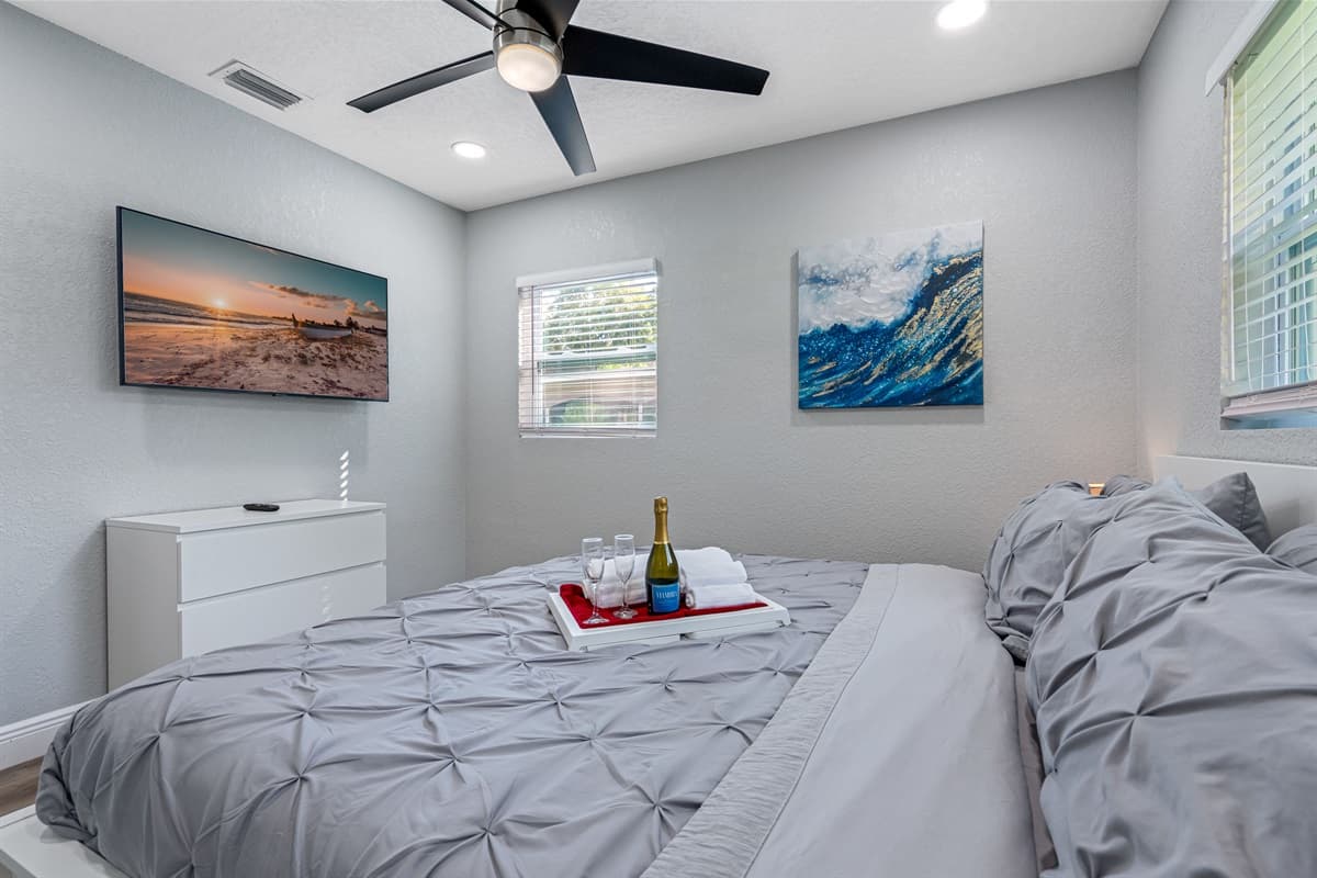 This comfortable bedroom has a king-size bed, full length mirror closet, and its own TV. Who wouldn't want a comfortable room to rest in after a long day at the beach?