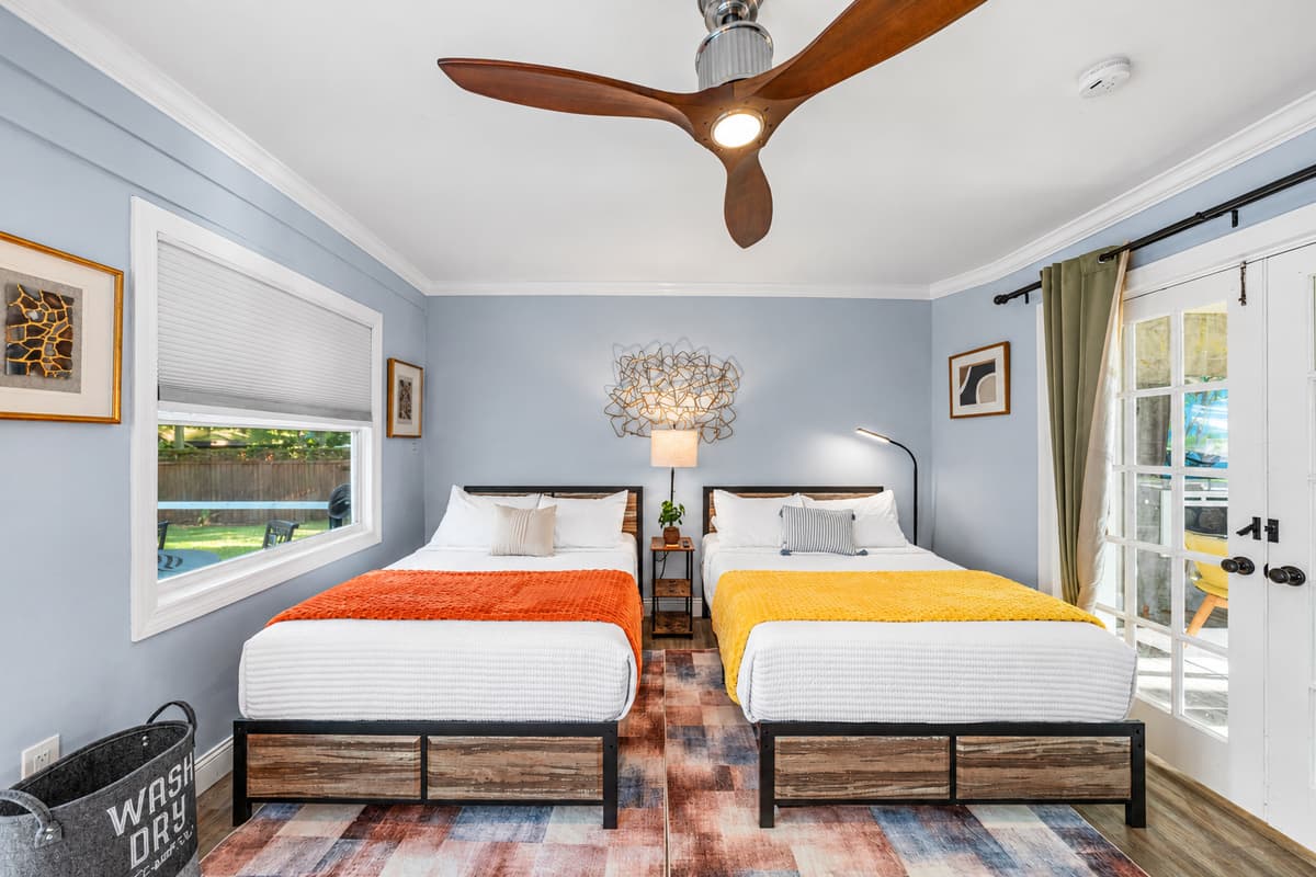Enjoy plenty of sleeping space in this inviting bedroom with two double beds and cozy, stylish décor.