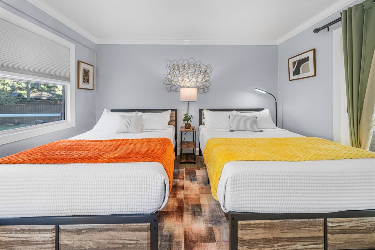 Designed for shared comfort, this bedroom offers two double beds with plush linens and a bright, welcoming atmosphere.