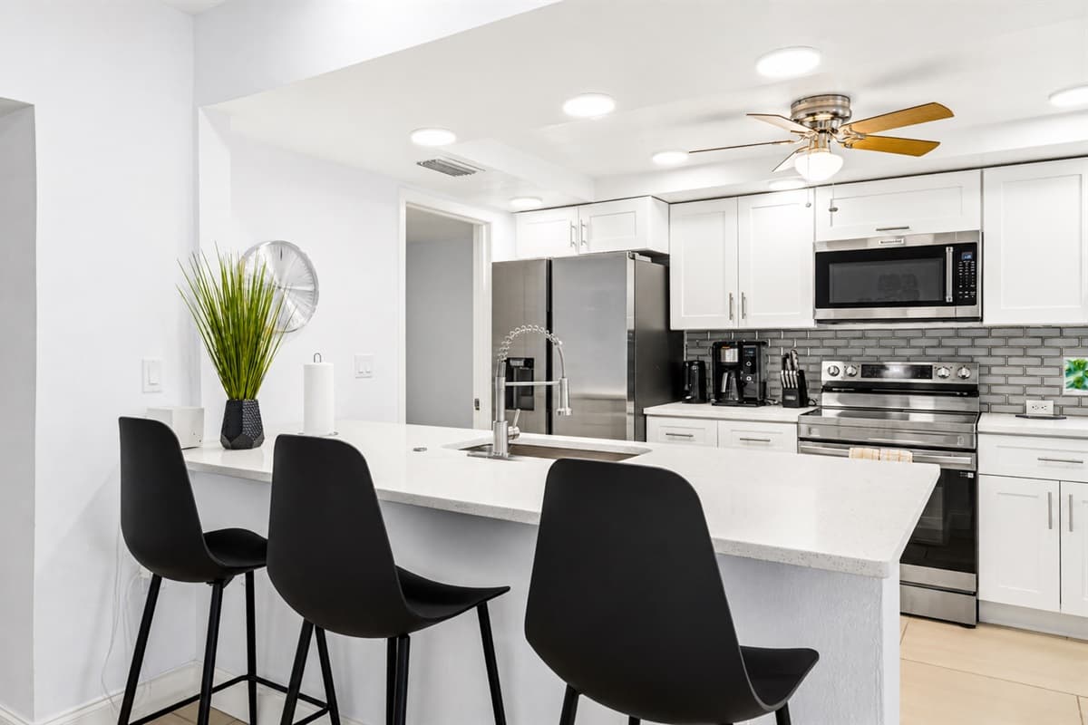 Contemporary kitchen with breakfast bar, stainless steel appliances, and elegant modern finishes.