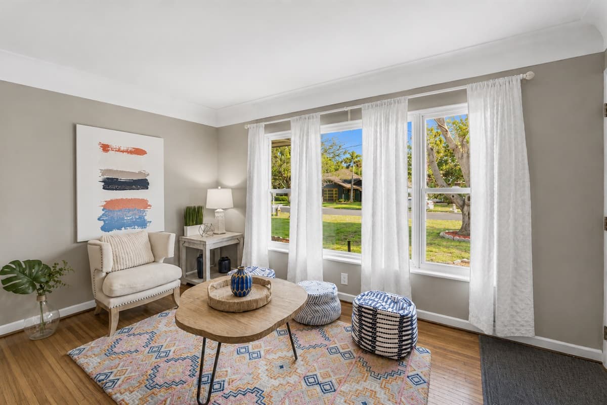 Relaxing conversation area near the entryway with chic décor and peaceful outdoor views.