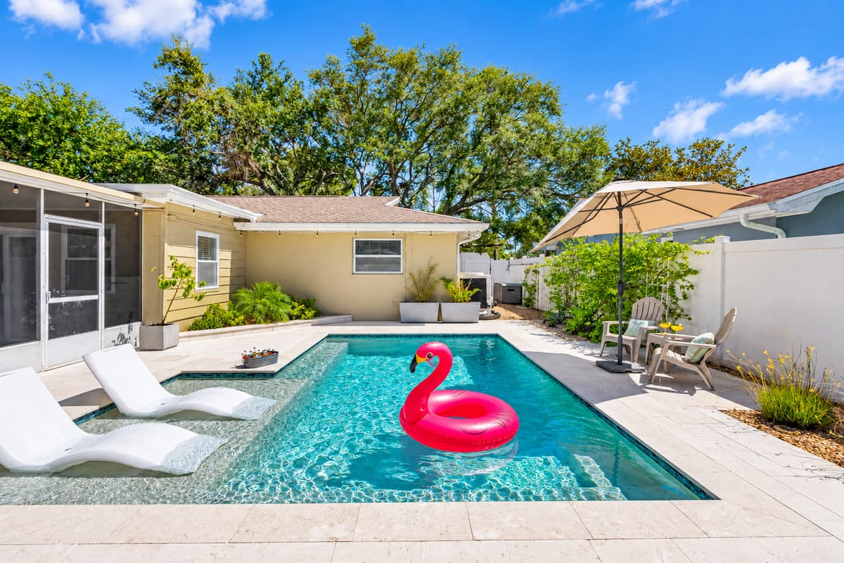 Enjoy breezy mornings or relaxing evenings in this spacious screened-in patio overlooking the pool.