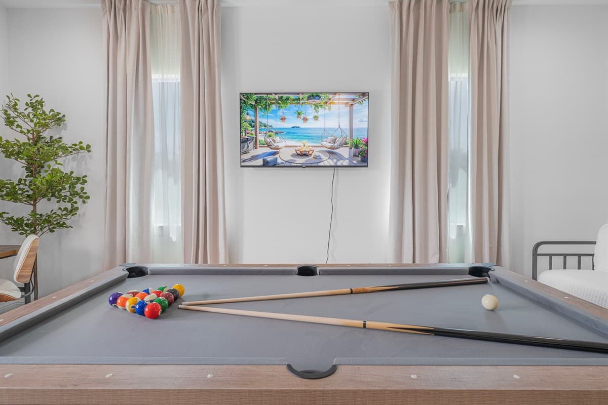 Detailed view of the pool table with balls and cues, set up for a relaxing game night.
