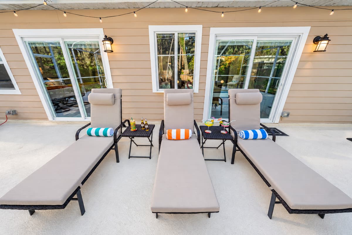 This serene pool area offers a relaxing retreat with comfortable loungers and a spacious screened enclosure.