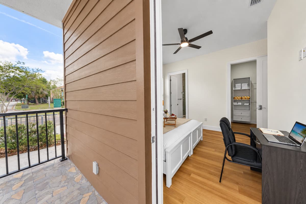 The private covered patio opens directly from Bedroom 1.
