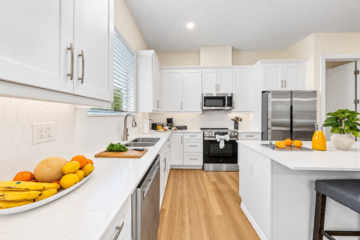 Modern kitchen with sleek cabinetry, stainless steel appliances, and open layout.