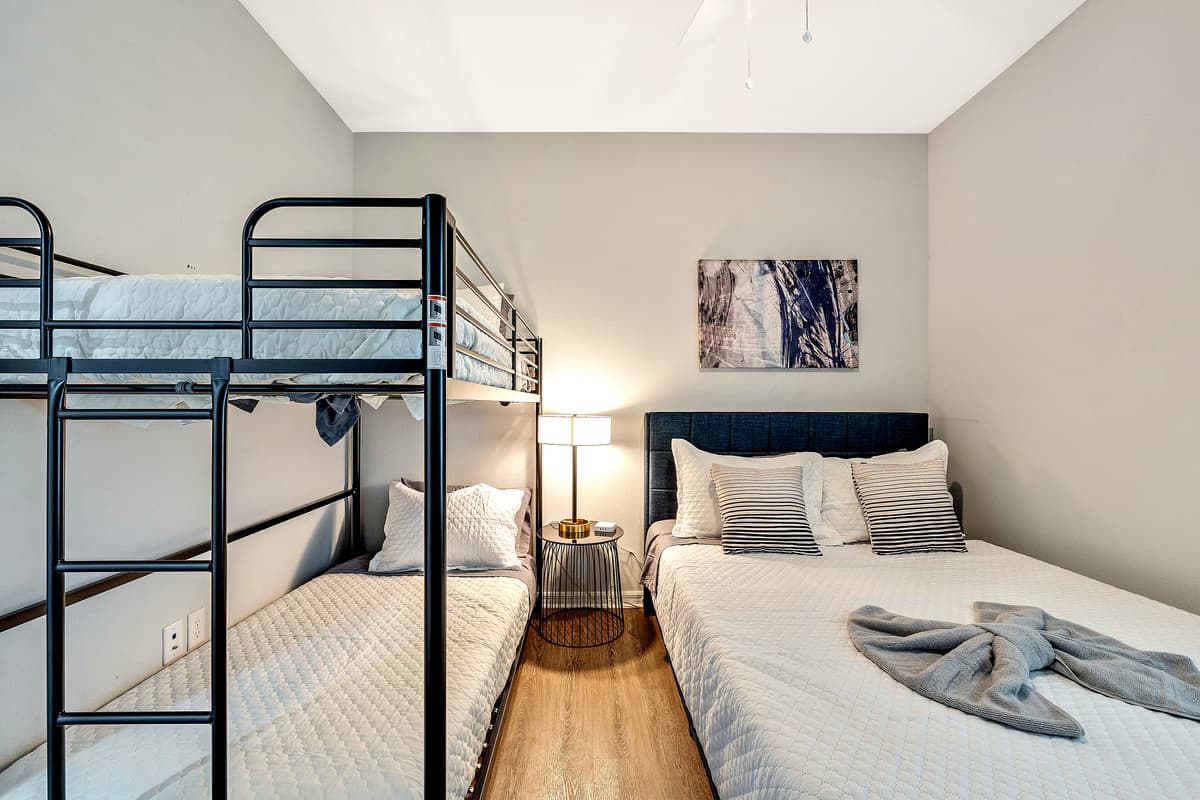 he queen-size bed provides a serene escape, while the bunk bed introduces an element of fun and flexibility for those with a penchant for unconventional sleeping arrangements.