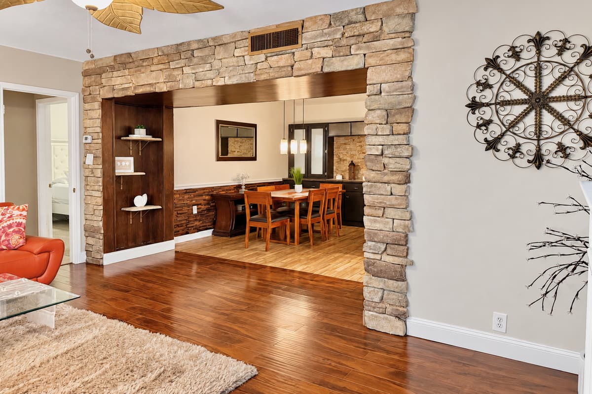 This elegant dining nook features rich wood tones, cushioned seating, and a chic centerpiece, creating a welcoming space for breakfast, dinner, or anything in between.