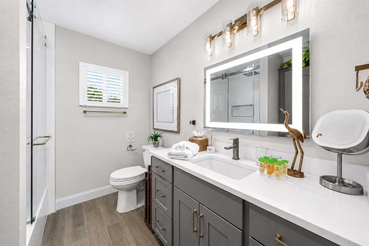 Spacious bathroom with double vanity sinks, large mirror, and sleek modern décor.