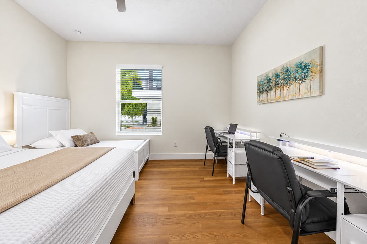 Bright bedroom with desk area and plenty of space to relax or work.
