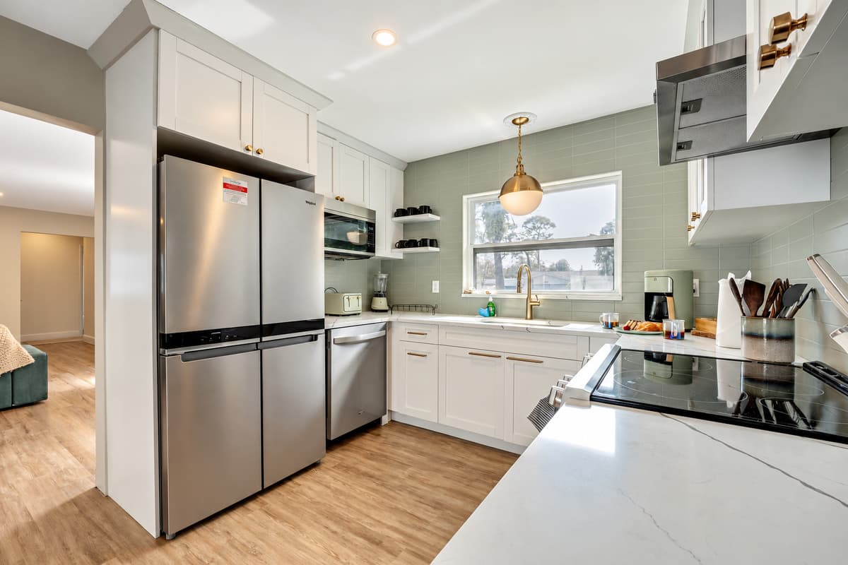 The kitchen welcomes you with its spacious layout, offering ample room for culinary endeavors and social gatherings alike.