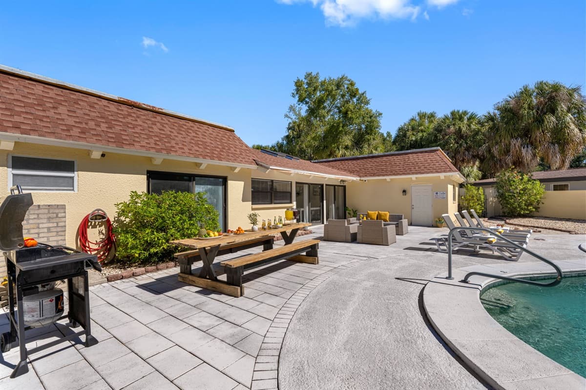 This spacious pool deck comes complete with loungers, a BBQ grill, and a dining table — perfect for enjoying Tampa’s sunny days and starry nights.