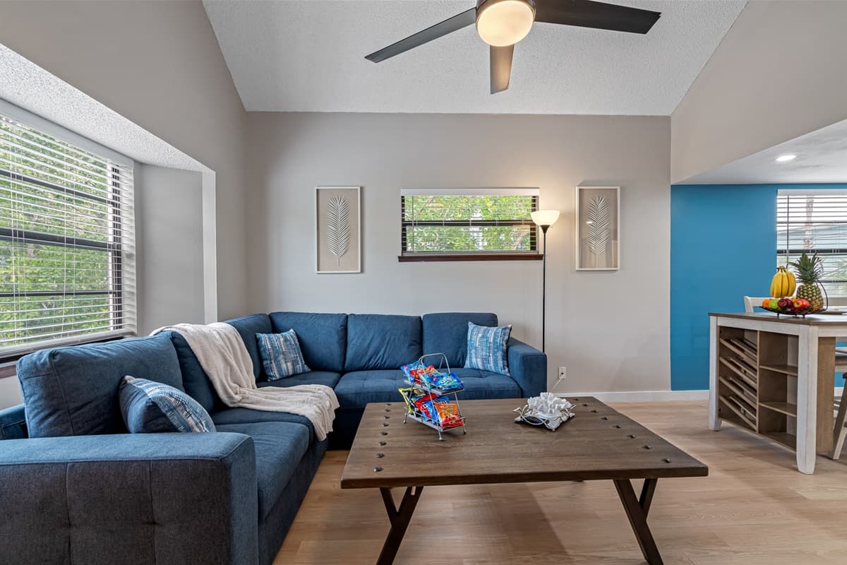 The centerpiece of the room is the exquisite blue sofa, beckoning you to sink into its luxurious cushions and unwind.