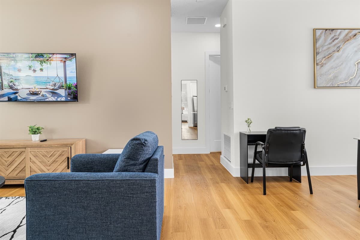 Open-concept living area with comfortable seating, a workspace, and room for everyone to gather.