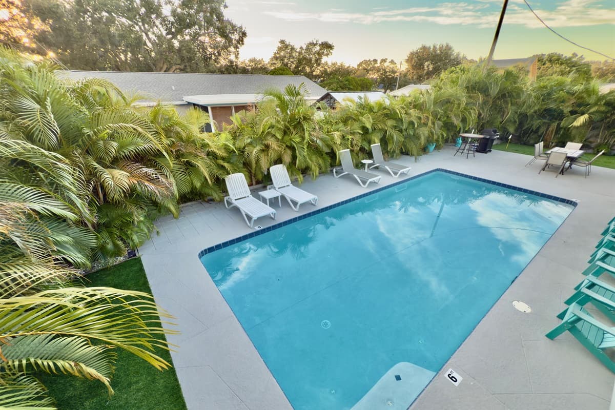 Relax in your private pool oasis, complete with lounge chairs and tropical greenery for maximum privacy.