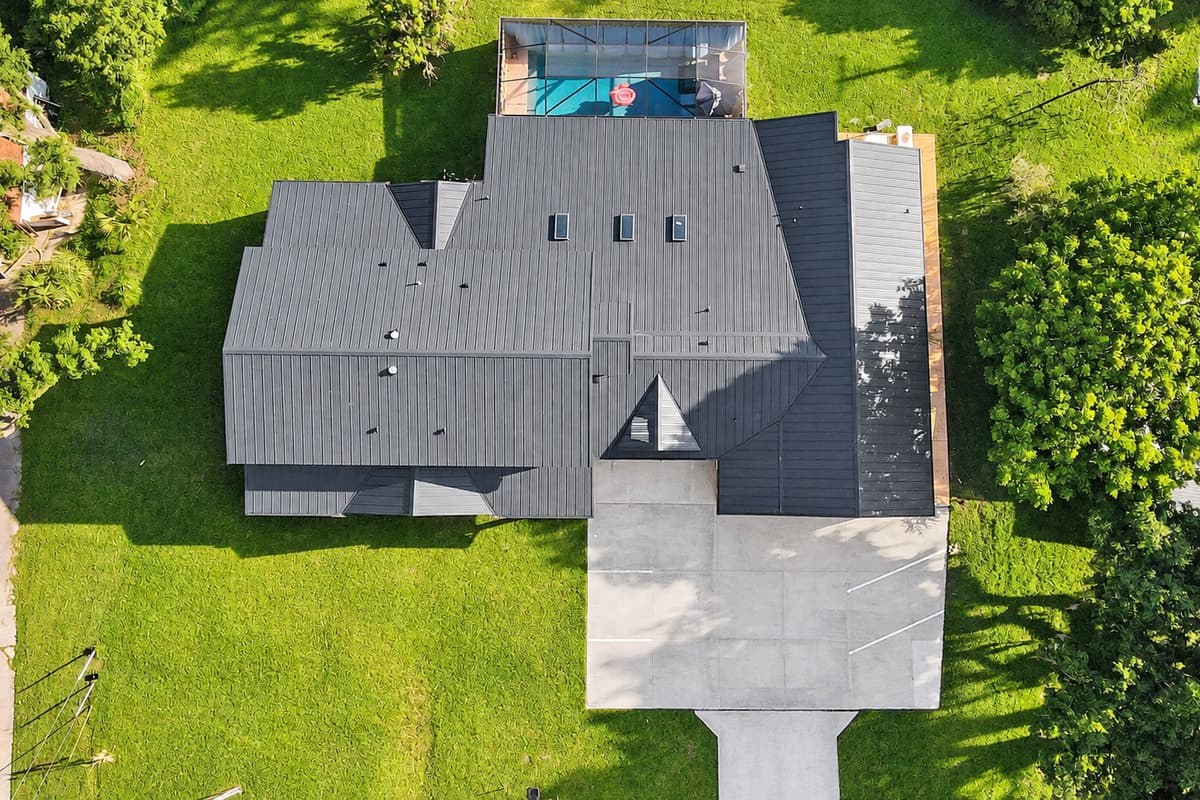 Look how much of this is just yours. Roofline, pool enclosure, driveway and lawn — an entire private compound rather than a house squeezed onto a small lot.