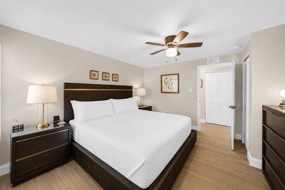 Modern king bedroom with elegant furnishings, soft lighting, and peaceful relaxing atmosphere.