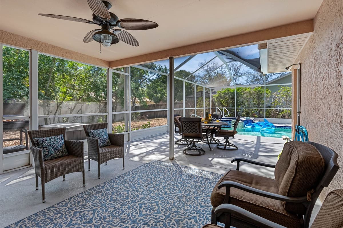 While the surrounding patio area is beautifully appointed with comfortable seating, a dining table, and plenty of space to stretch out and relax.