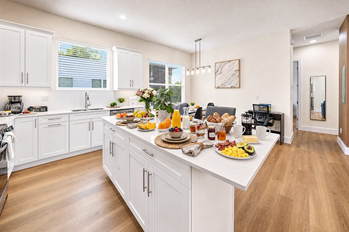 White shaker cabinets, gleaming countertops, and a full-size dishwasher. Cooking in and cleaning up has never been this easy.