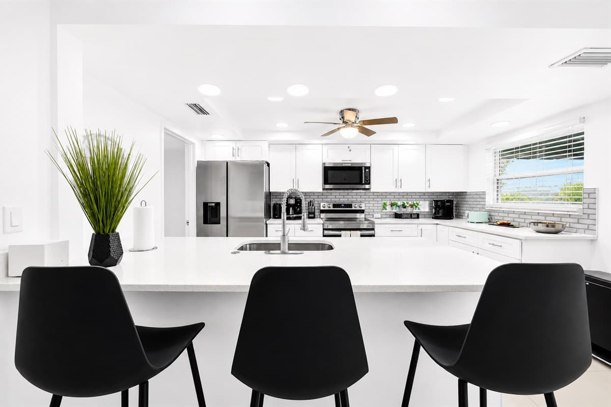 Large kitchen island with bar seating, perfect for gathering, dining, and entertaining.
