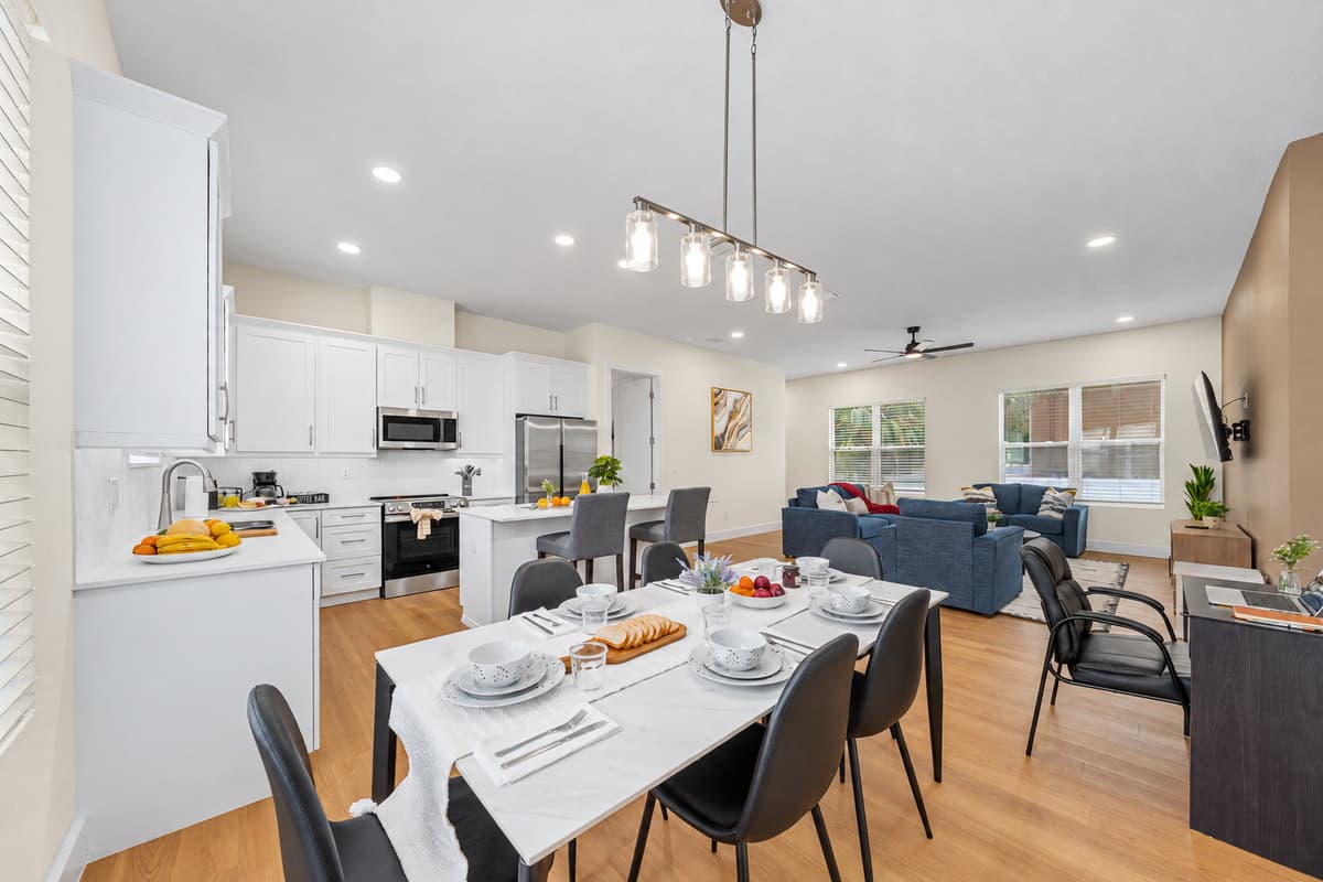 Bright open-concept living, dining, and kitchen area with room for the group to gather.