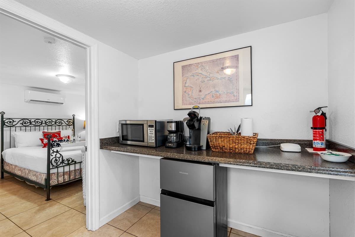 This charming bedroom is designed to offer the perfect blend of comfort and convenience, with the added luxury of a kitchenette right inside the room.