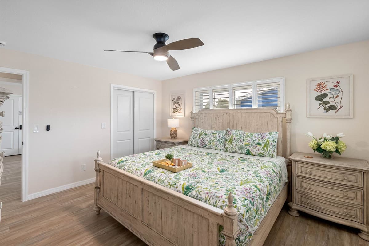 This bedroom blends cozy comfort with timeless design, offering a king bed, matching nightstands, and a dresser with plenty of storage space.