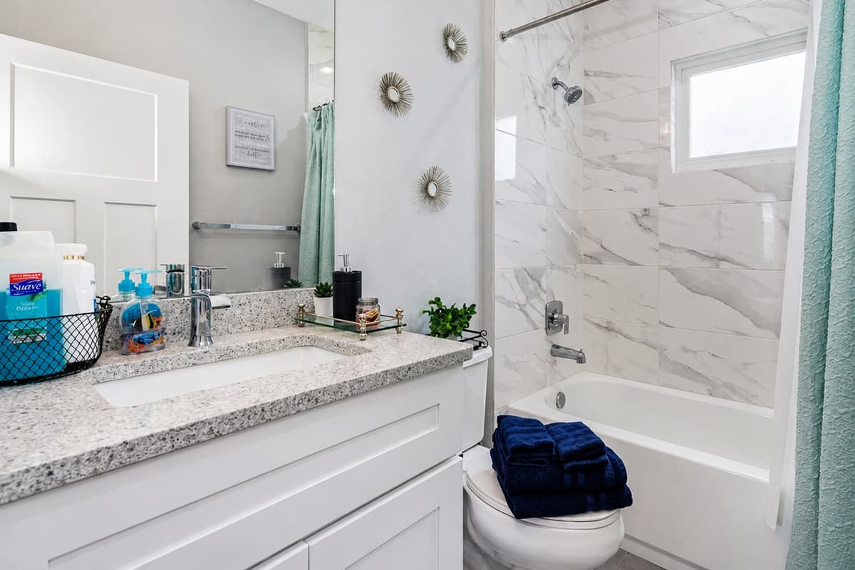 Stunning bathroom with bathtub, sink, toilet and walk in shower.  Enjoy a relaxing bath after a long day of travel from your home to your home away from home. If you like this property, send us a message now!