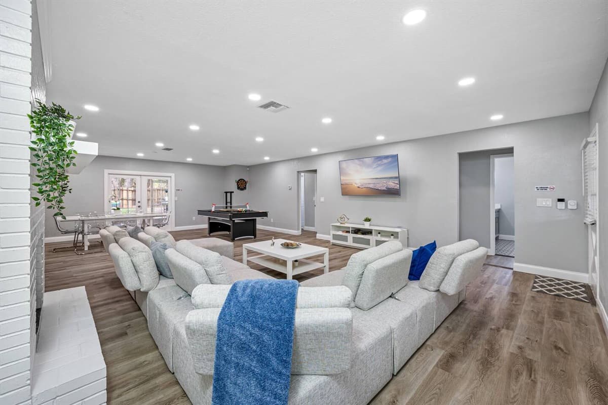 Elegant living room with a beautiful L-shaped couch, smart TV and pool table. relax and enjoy with family and friends in the comfort of your home away from home. Do you love what you see? Send us an inquiry now!