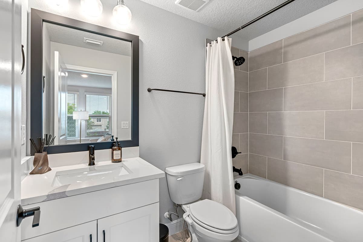 A sanctuary of modern design, featuring sleek fixtures, clean lines, and tasteful accents that elevate the space to new heights of sophistication.
