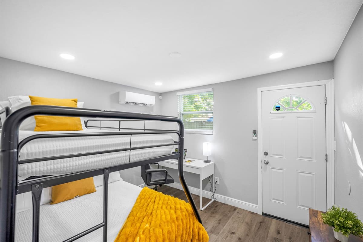 Bright natural light and bold yellow accents bring warmth and energy to this inviting room.