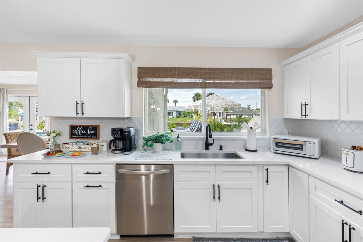 With light wood floors, soft tones, and modern lighting, this kitchen blends coastal charm with everyday functionality.