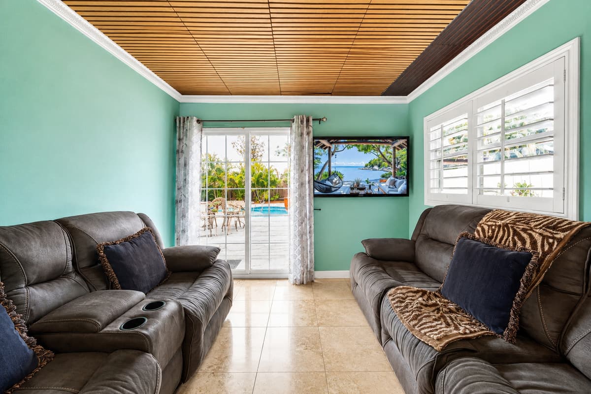 Enjoy beautiful backyard views and easy access to the pool from the second living area.