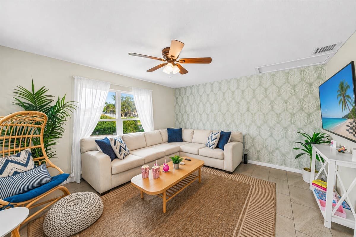 Bright and airy lounge space with natural light, cozy seating, and coastal décor.