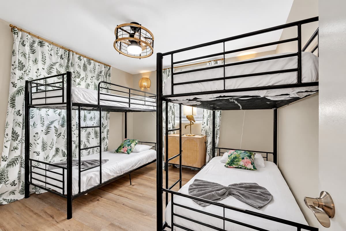 This inviting room is adorned with two bunk beds, offering ample space for rest and relaxation in a cozy and welcoming atmosphere.