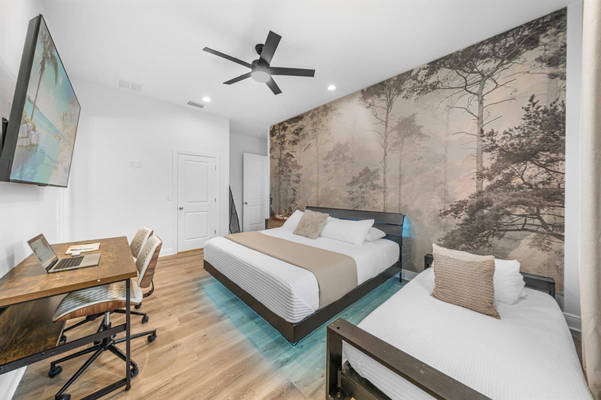 Bright bedroom view highlighting large windows, comfortable bedding, and serene atmosphere.