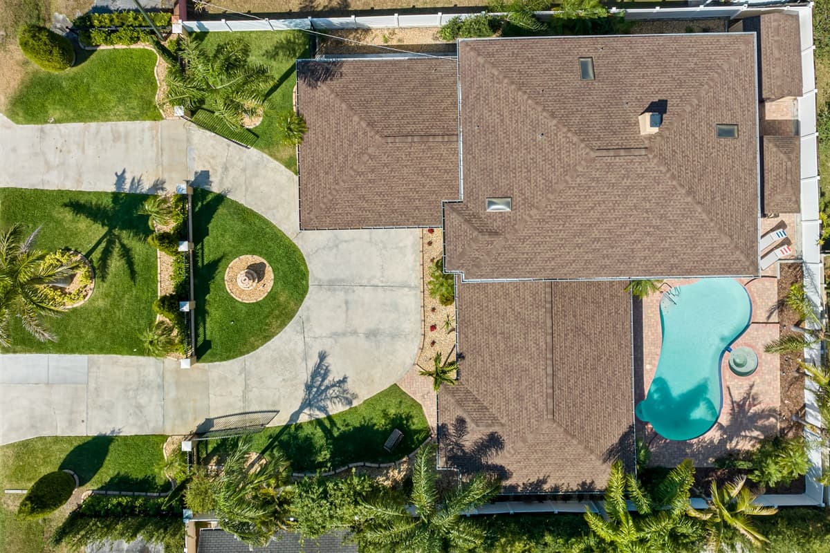 Aerial view of the house boasting its beautiful in-ground pool.