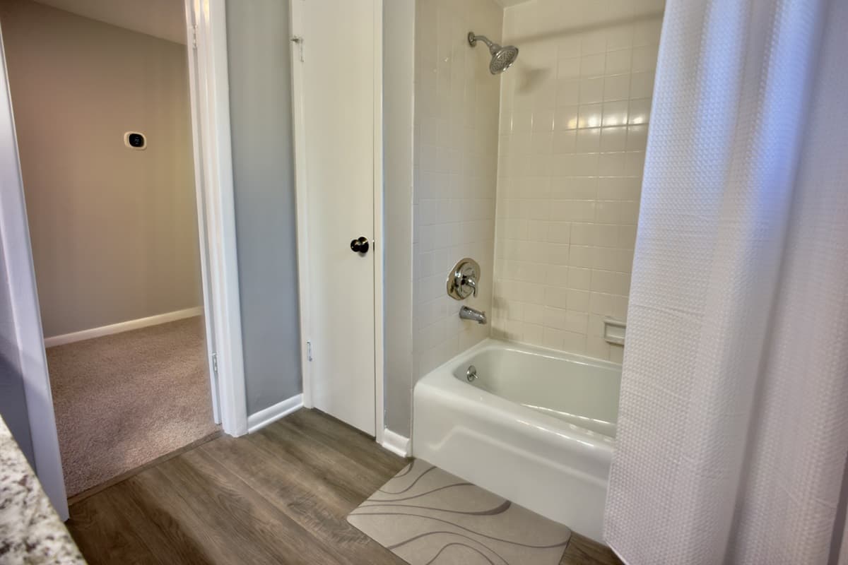 A serene retreat featuring a tub and shower combination, perfect for unwinding after a long day.