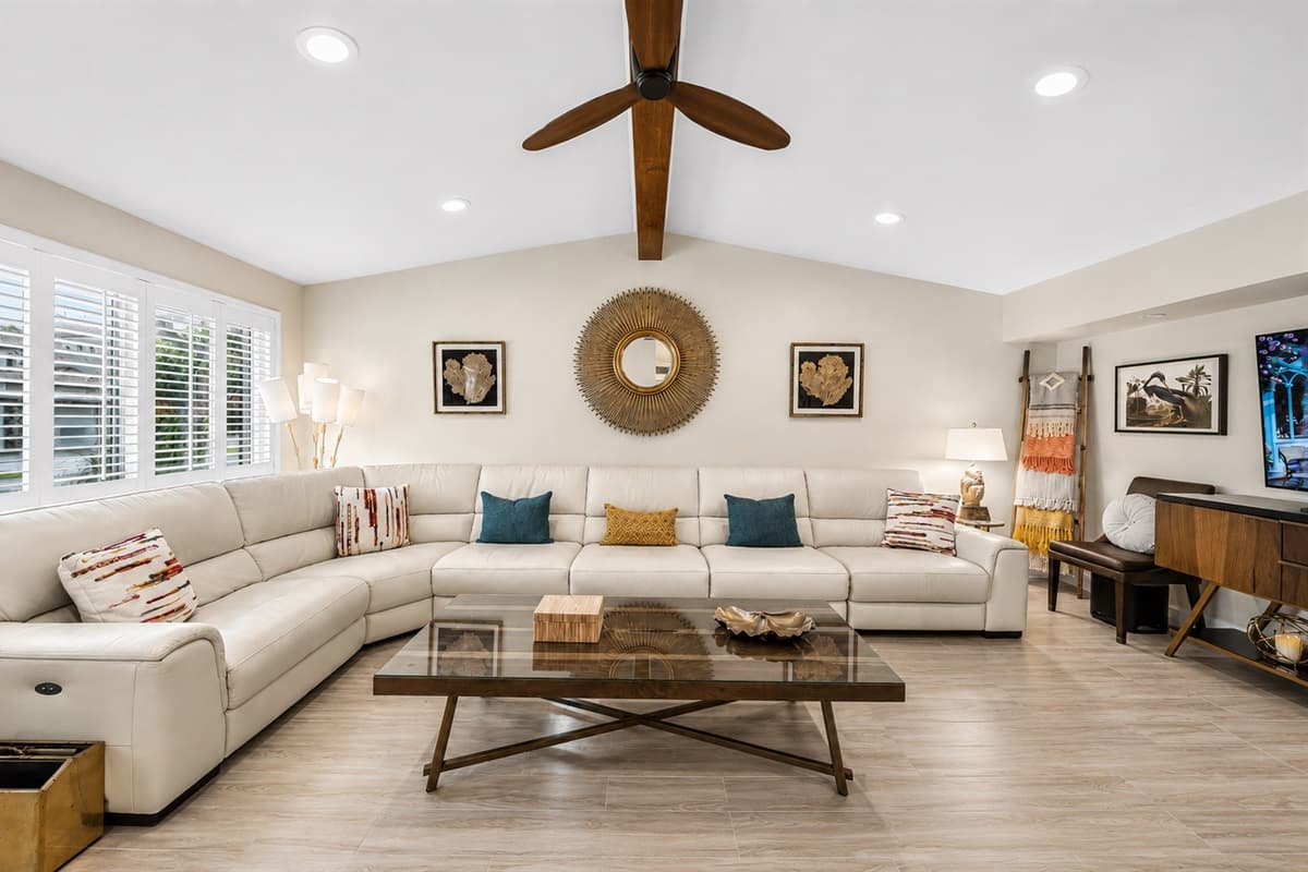 Spacious and beautifully designed living room featuring oversized sectional seating, vaulted ceilings, and cozy modern décor.