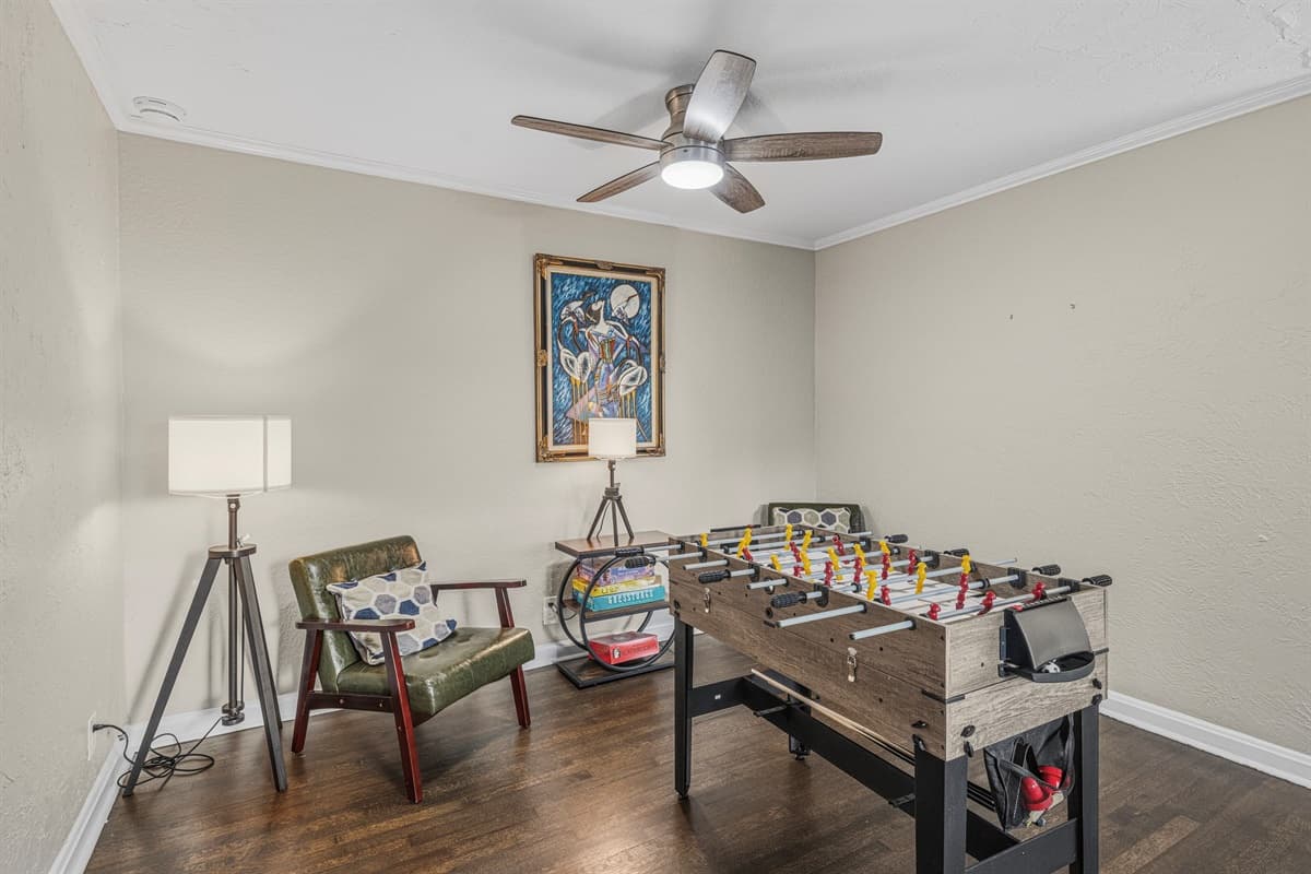 Fun-filled game room featuring a foosball table and cozy seating for friendly competition.