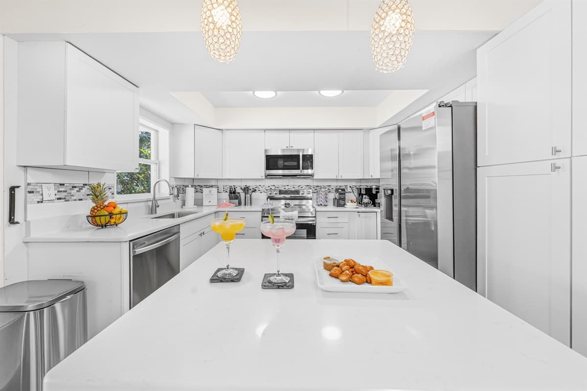 Large kitchen island provides the perfect gathering spot for meals, drinks, and conversation.