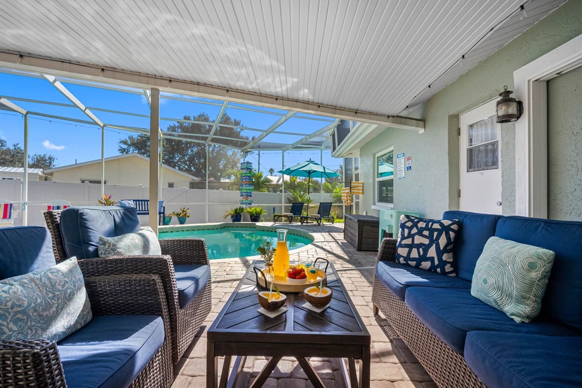 Relax in style under the shaded lanai with plush outdoor seating, perfect for morning coffee, evening cocktails, or simply lounging between swims.