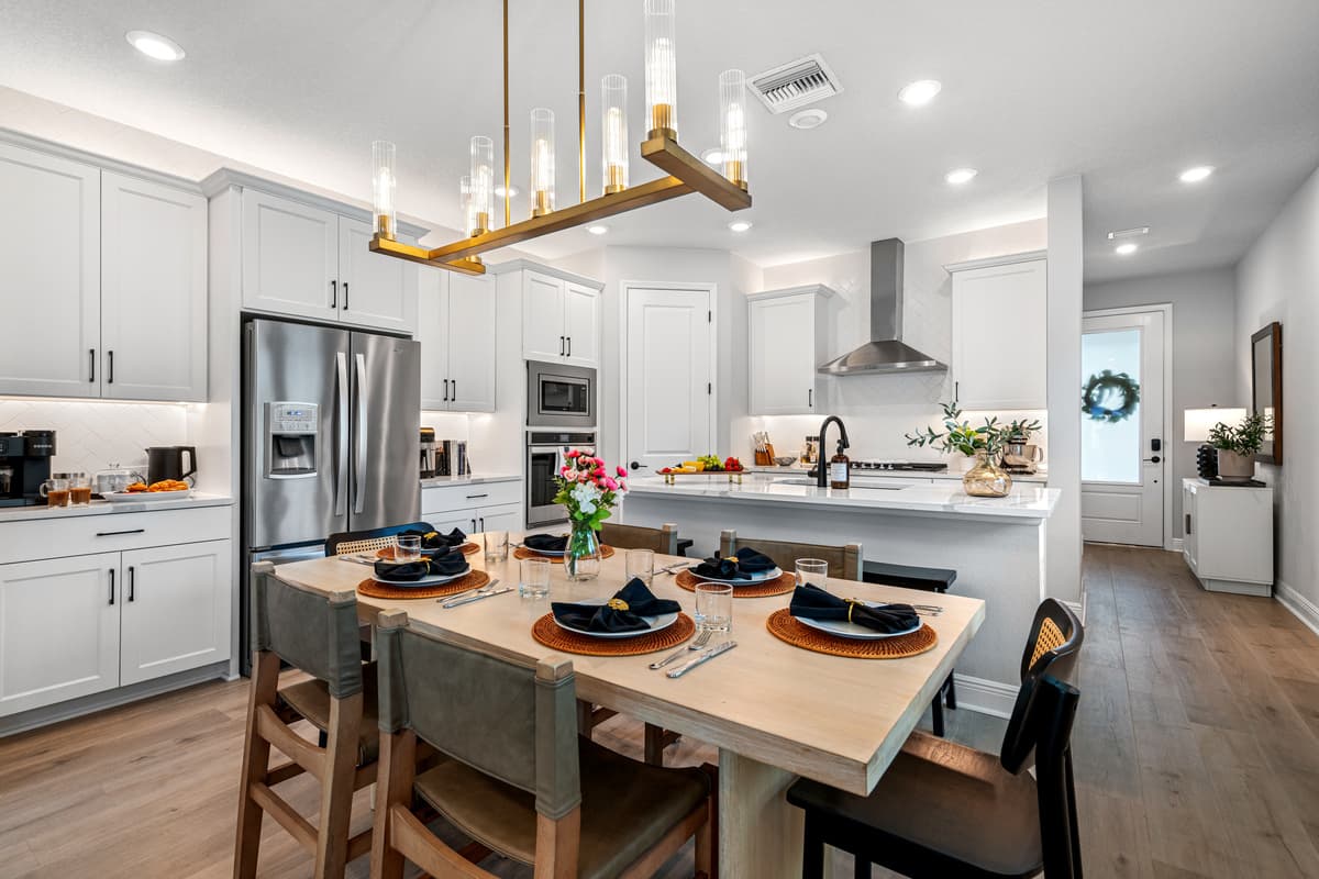 Cook without leaving the room. Island seating on one side, six chairs on the other, everyone in the same conversation